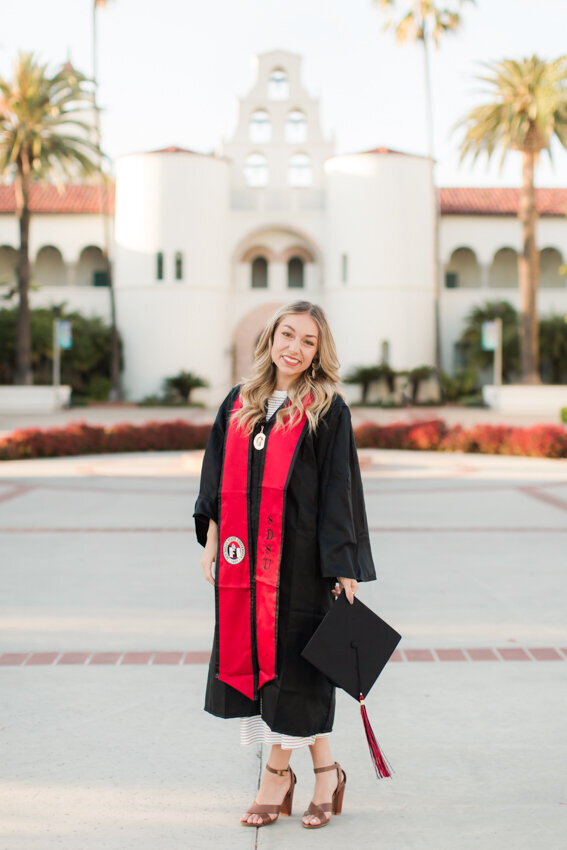 San Diego State senior in robes in front of Hepner Hall
