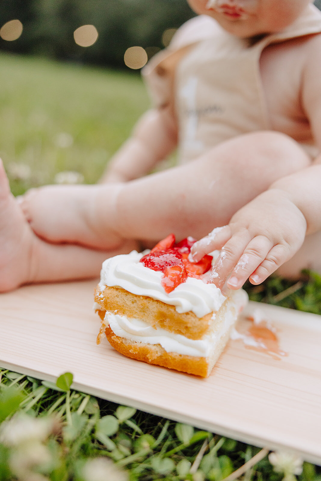 Baby trying their birthday cake
