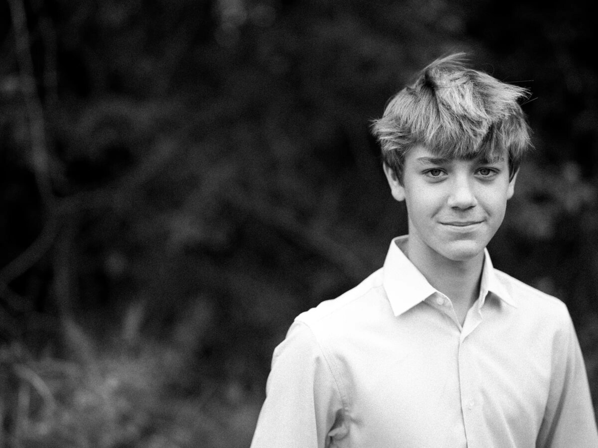 Black and white photo of a teenage boy smiling