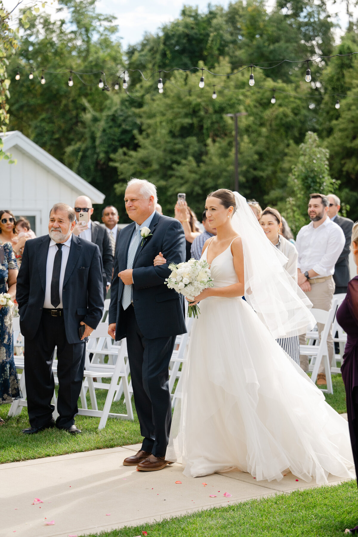 a father walks his daughter down the aisle at her wedding