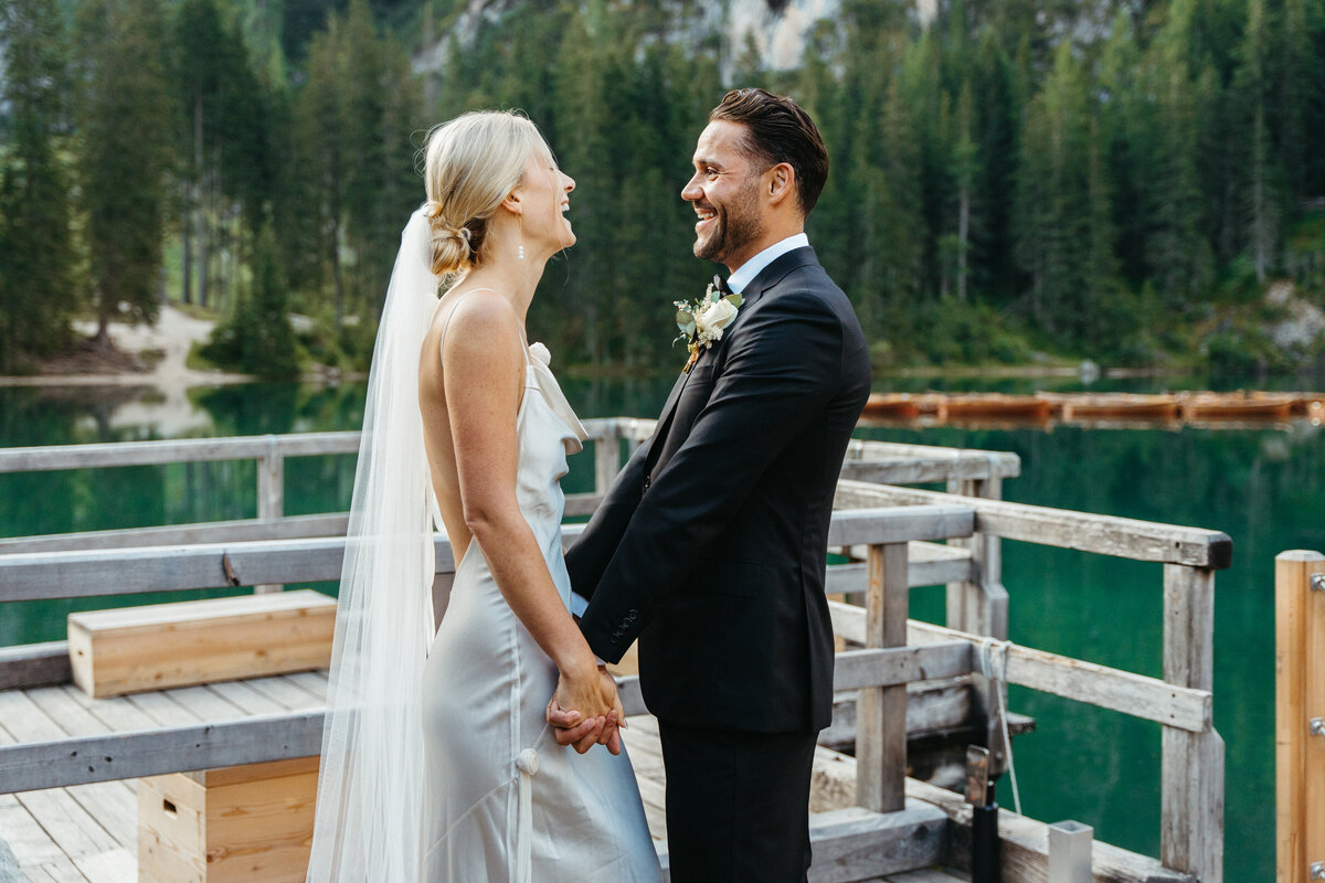 Close-up of couple holding hands in wedding attire