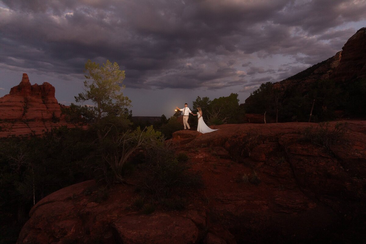 Couple celebrating their night elopement with glowing lanterns in Sedona, captured by Lamblight Photography