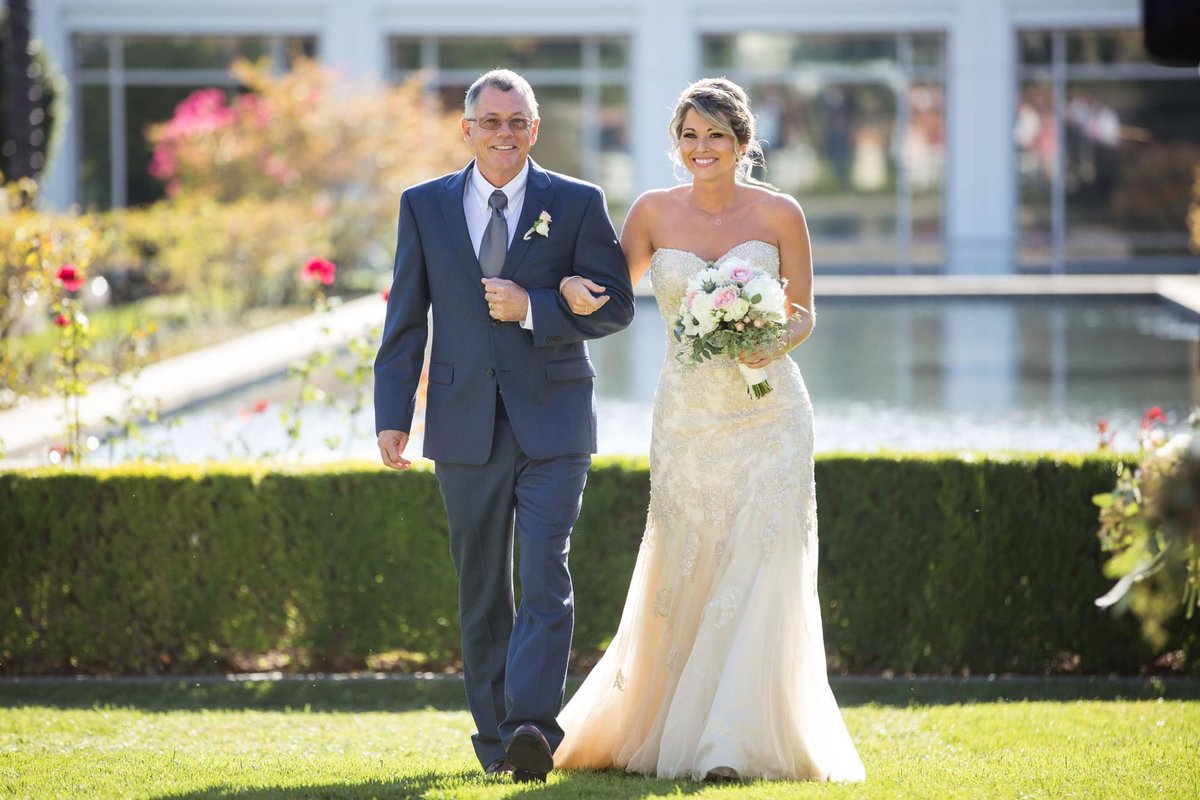 Bride being escorted up the aisle by her father