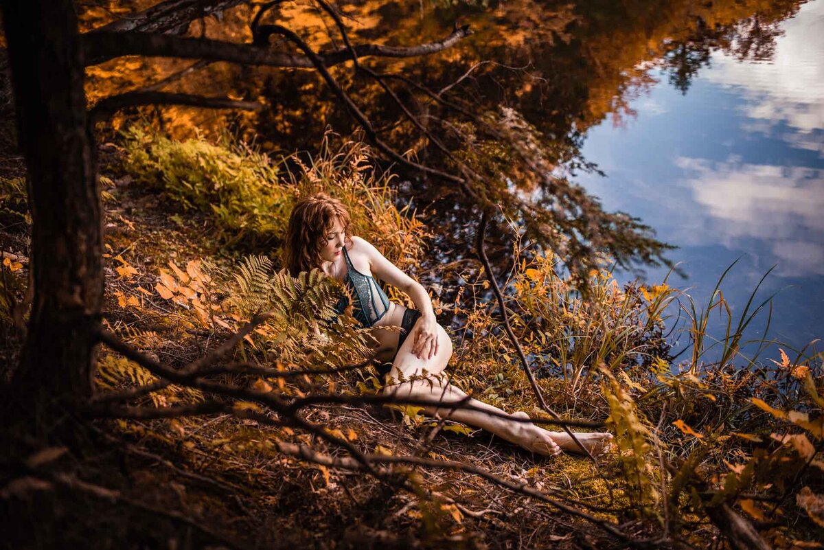 woman posing for outdoor forest boudoir photoshoot in Ottawa