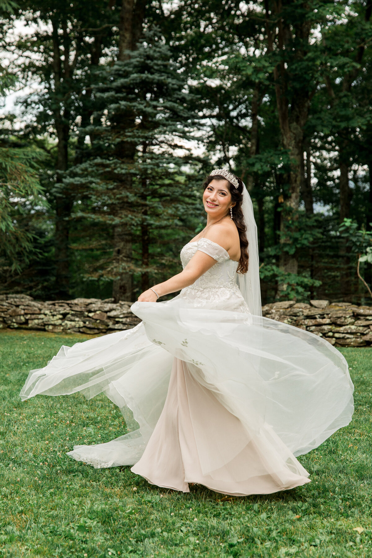 A bride spins in her wedding dress for a bridal portrait for a wedding photo in West Jefferson, NC