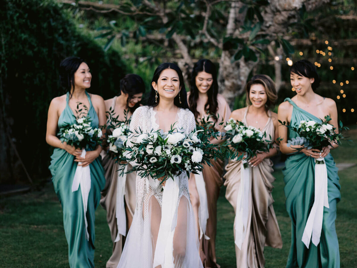 The bride and her bridesmaids are happily standing in Khayangan Estate, Bali, Indonesia. Image by Jenny Fu Studio