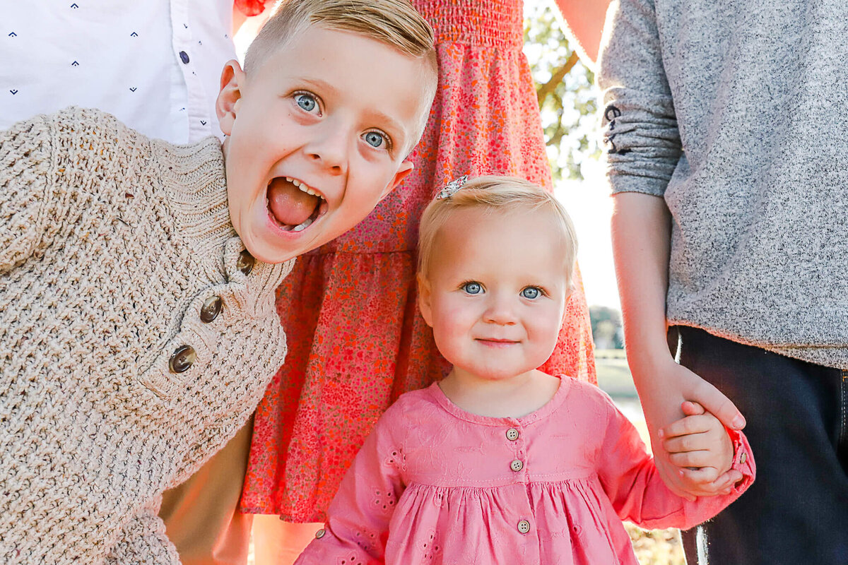 Brother and sister smiling at camera.