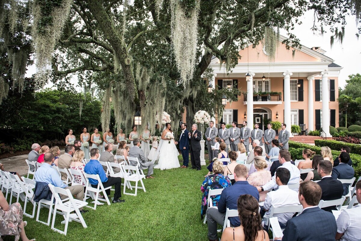 Southern Oaks wedding ceremony on lawn by large oak trree