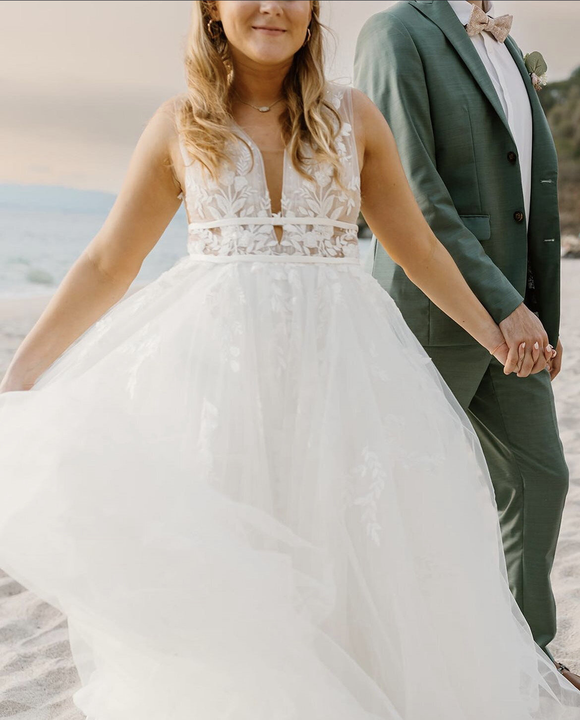 Bride and groom holding hands on the beach after a destination ceremony—styled with wedding mobile hair and makeup by Mistique Makeup.