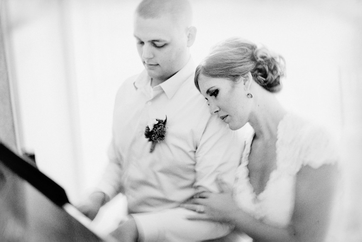 black and white photo of bride and groom at piano Omaha