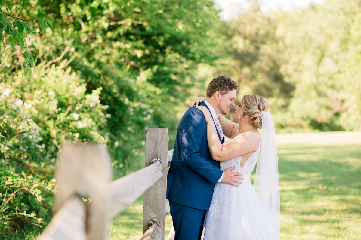 altoona wedding photo of couple in the sun by fence