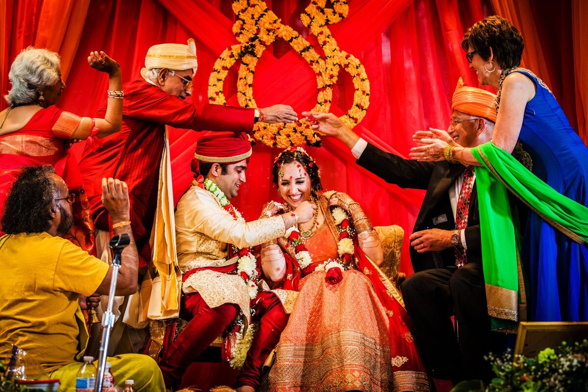 A couple is showered with rice at an Aurora Balaji temple wedding.