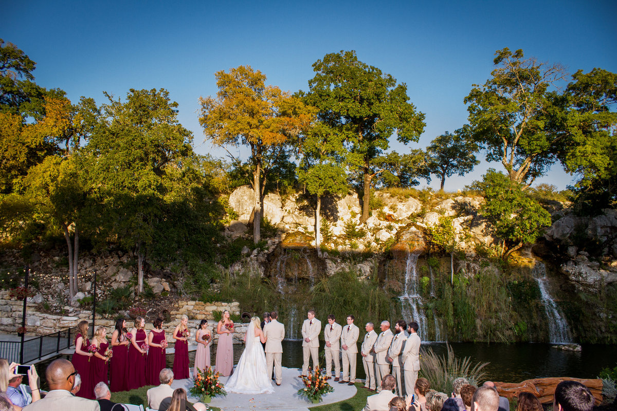 bridal party standing with bride and groom at wedding ceremony at Remi's Ridge at Hidden Falls Wedding venue
