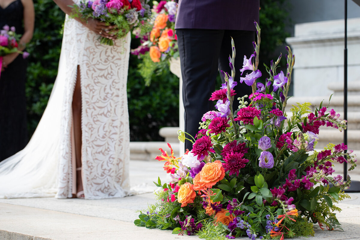 Fuschia, peach and lavender ground arrangement for wedding ceremony. Kim Pawley Helfgott is a garden inspired floral designer serving Easton, MD and St. Michaels, MD.