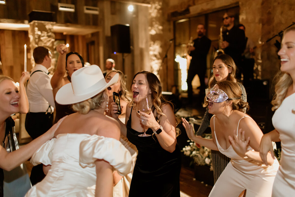 Fort Worth Wedding Photographer Megan Christine Studio captures a fun candid dance floor moment at Hotel Drover in the Stockyards. 