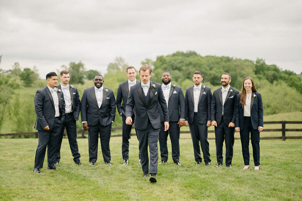 Groom and his groomsmen in an open field 