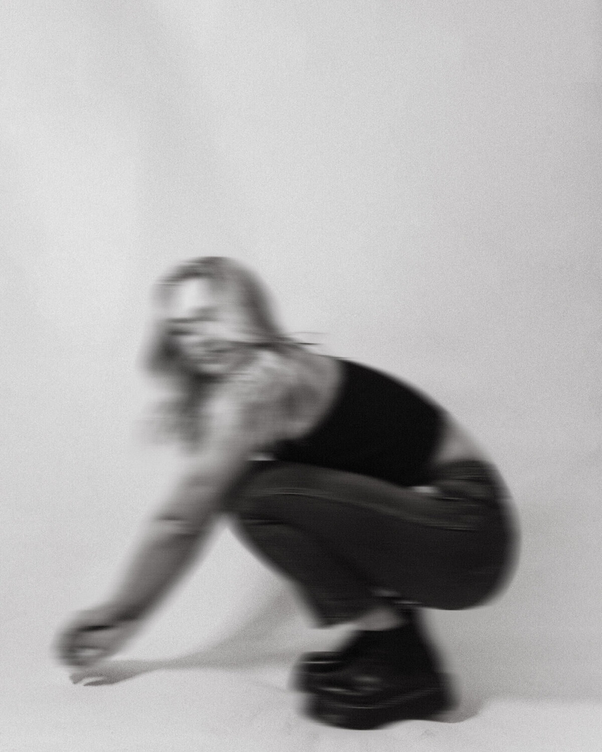 woman squatting on photo set blurry