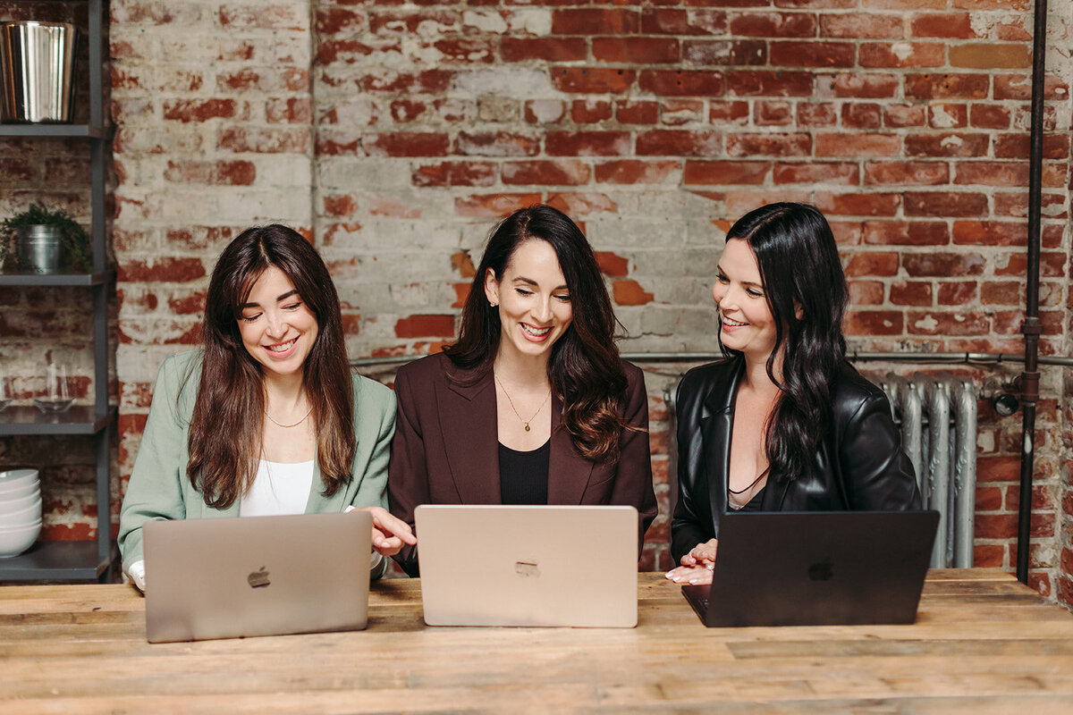 Utah Family Photographer captures women typing on computers during brand photoshoot