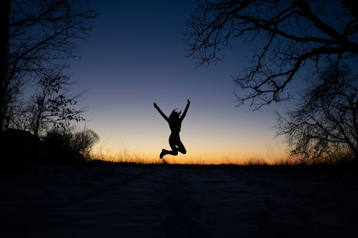 silloutte of jumping girl during Branson senior photography session