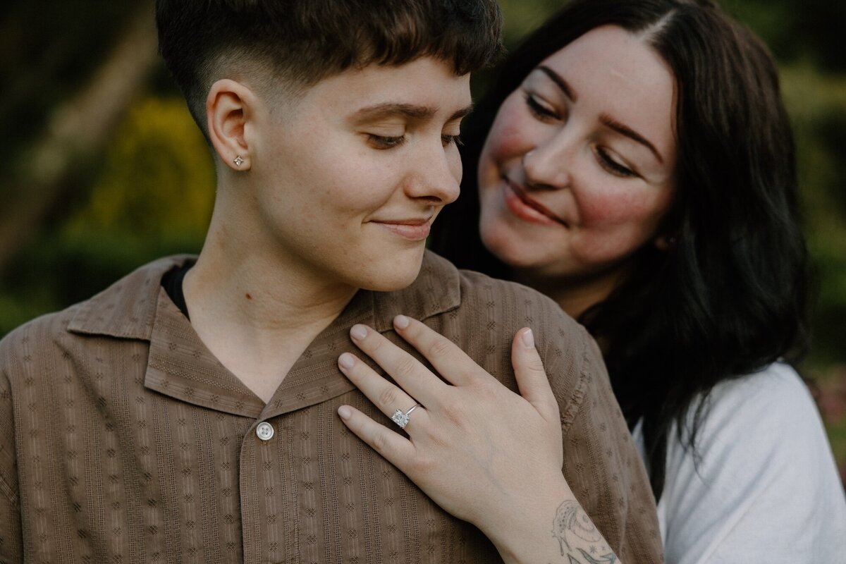 female engaged couple showing ring