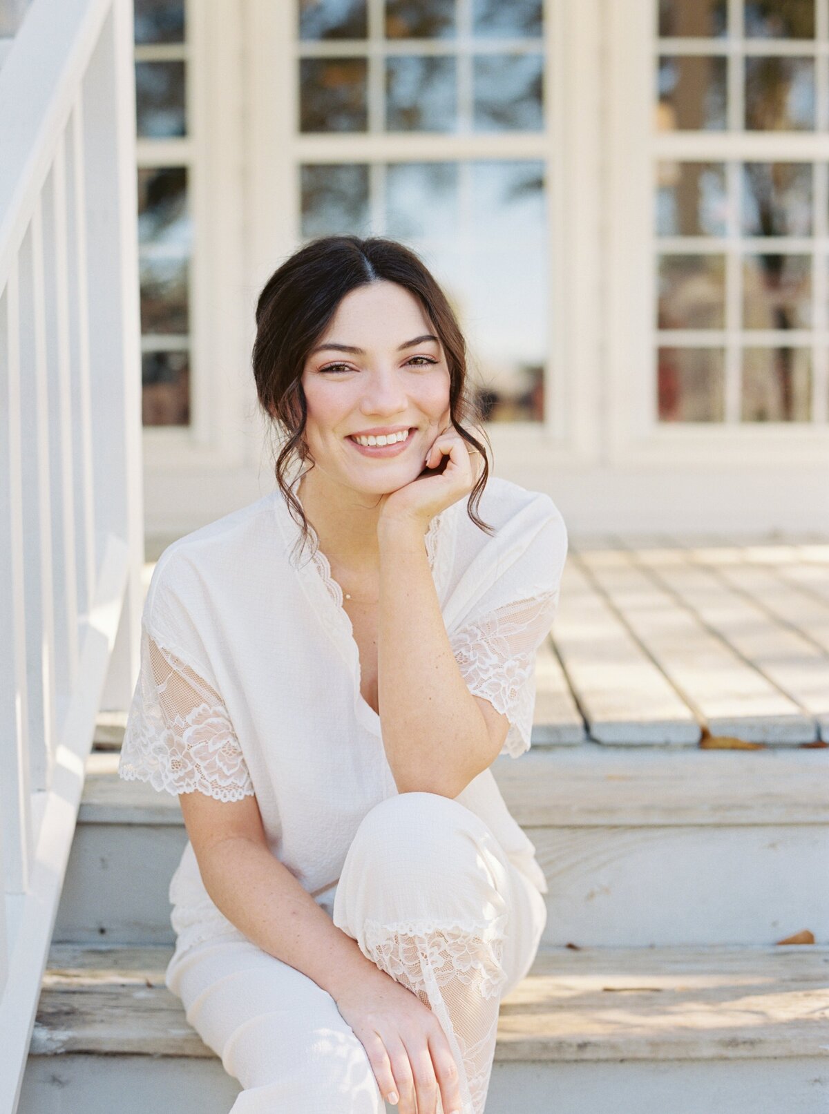 A serene moment of a bride savoring the fresh morning air on her wedding day, elegantly captured on film by Morgan Alysse, Louisiana film photographer.