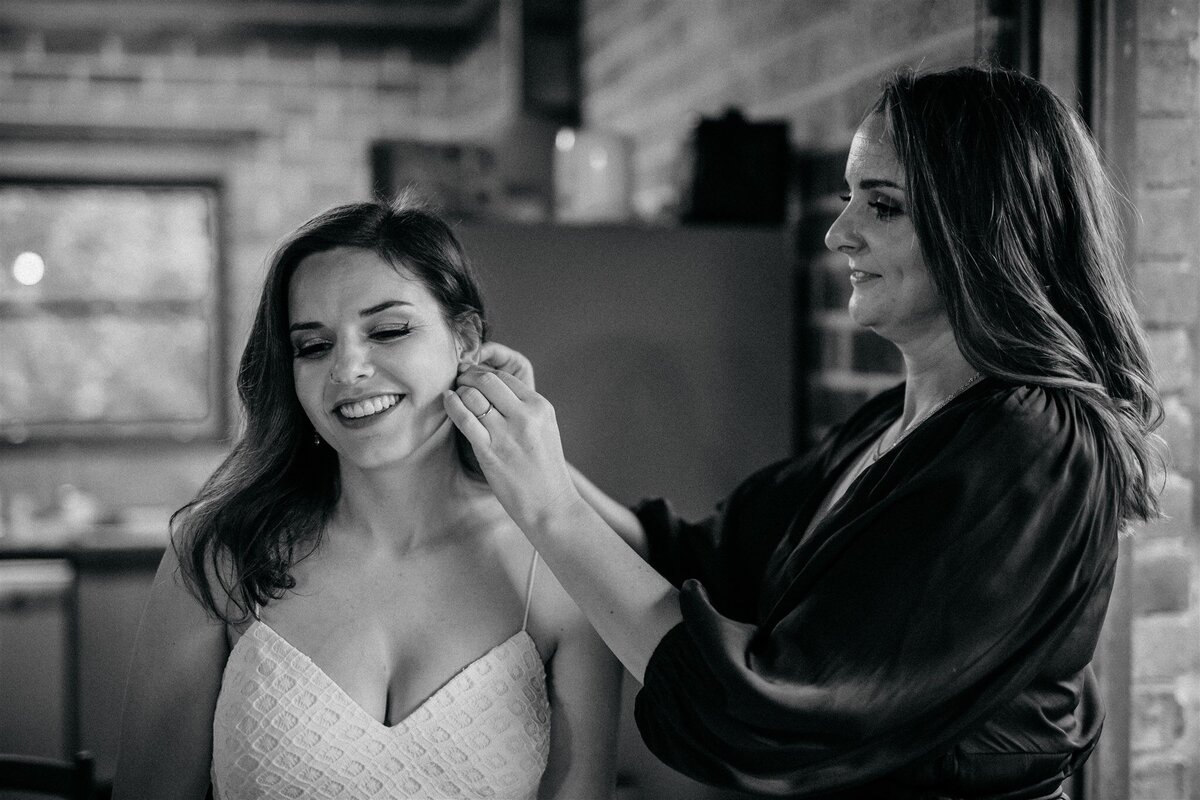 Beautiful Kara having her earrings clipped to her before her wedding ceremony