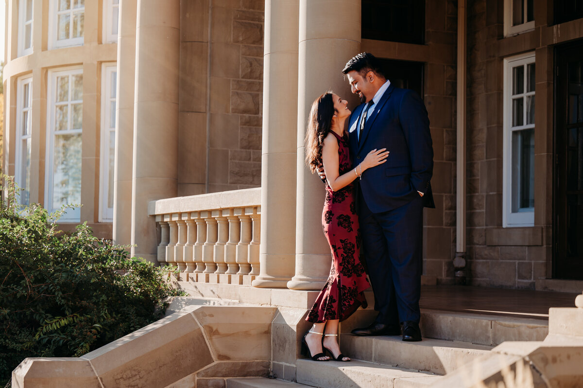 Engaged couple looking at each other with love in front of the Government house in Edmonton, Alberta