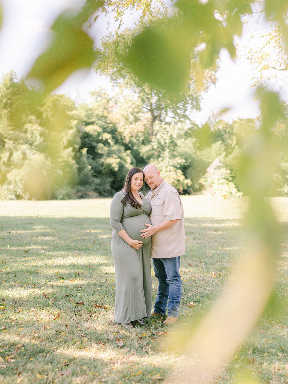 Pregnant wife and husband in field in Virginia