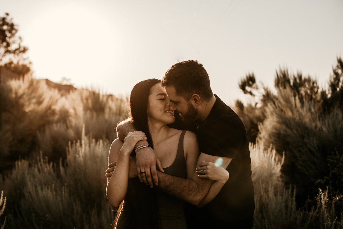 engaged couple about to kiss in Albuquerque desert