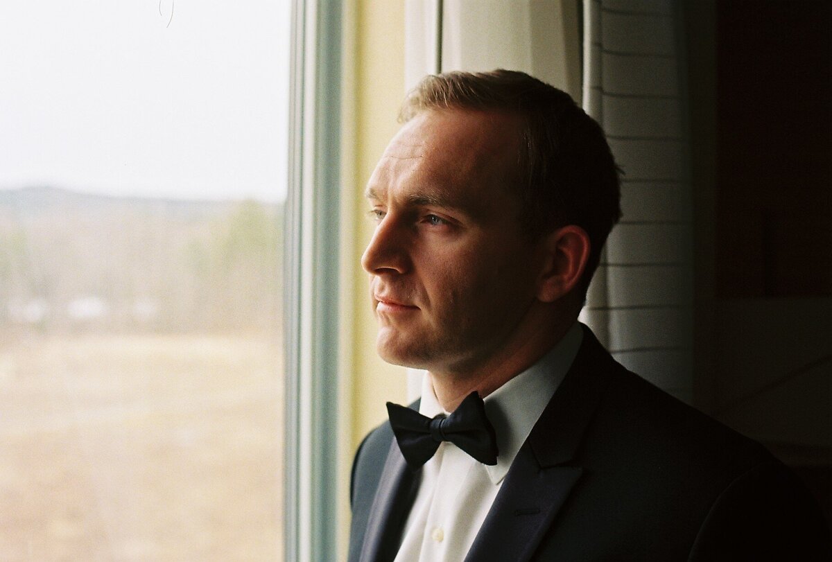 groom looking out window