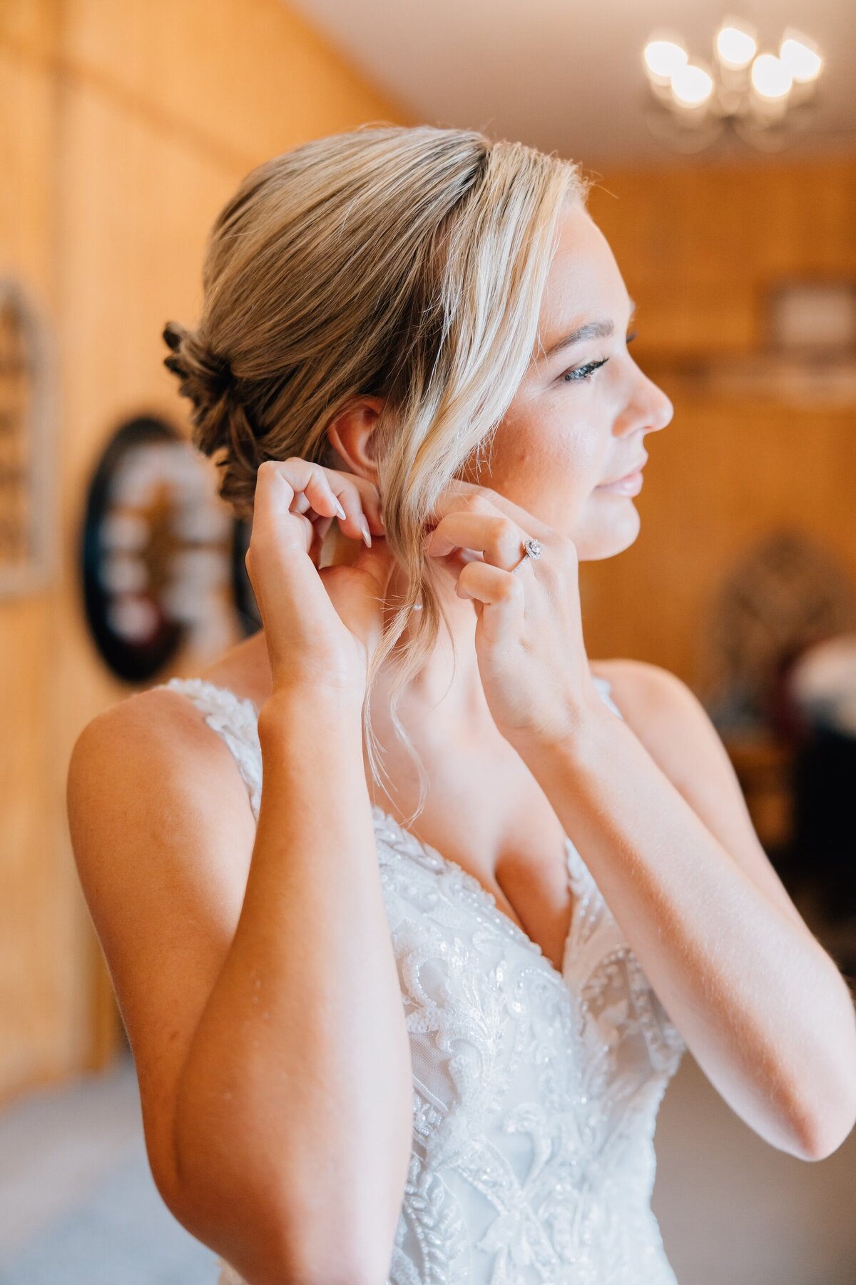 bride putting on earrings