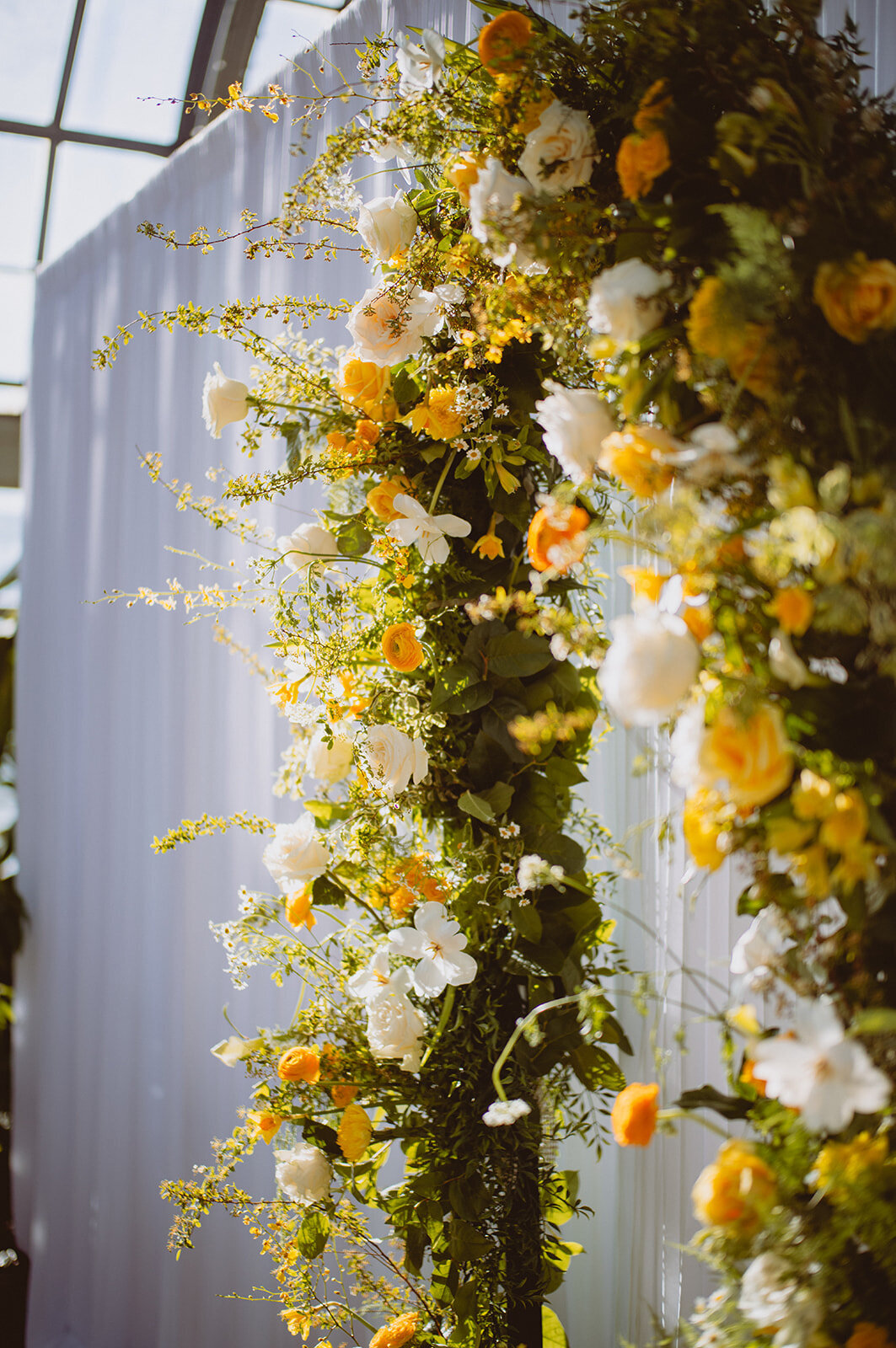 lush yellow white green full wedding arch