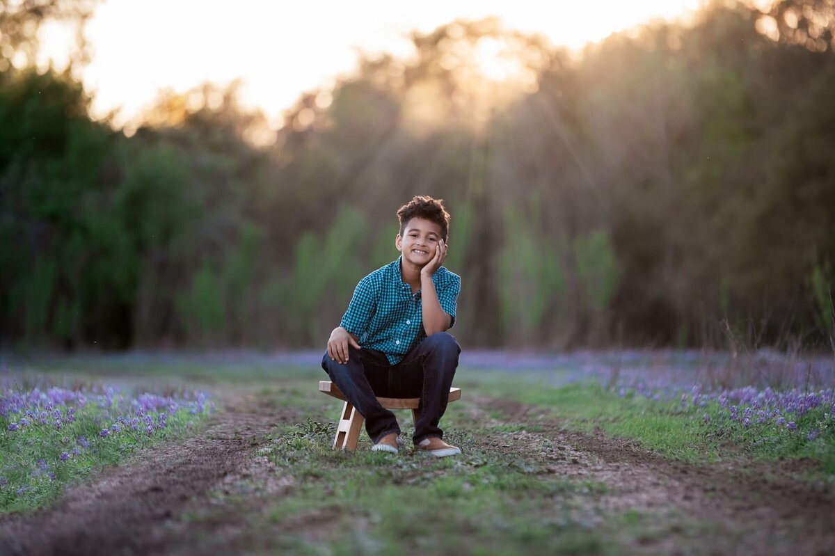 Jen’s son Deacon smiling in a casual outdoor portrait
