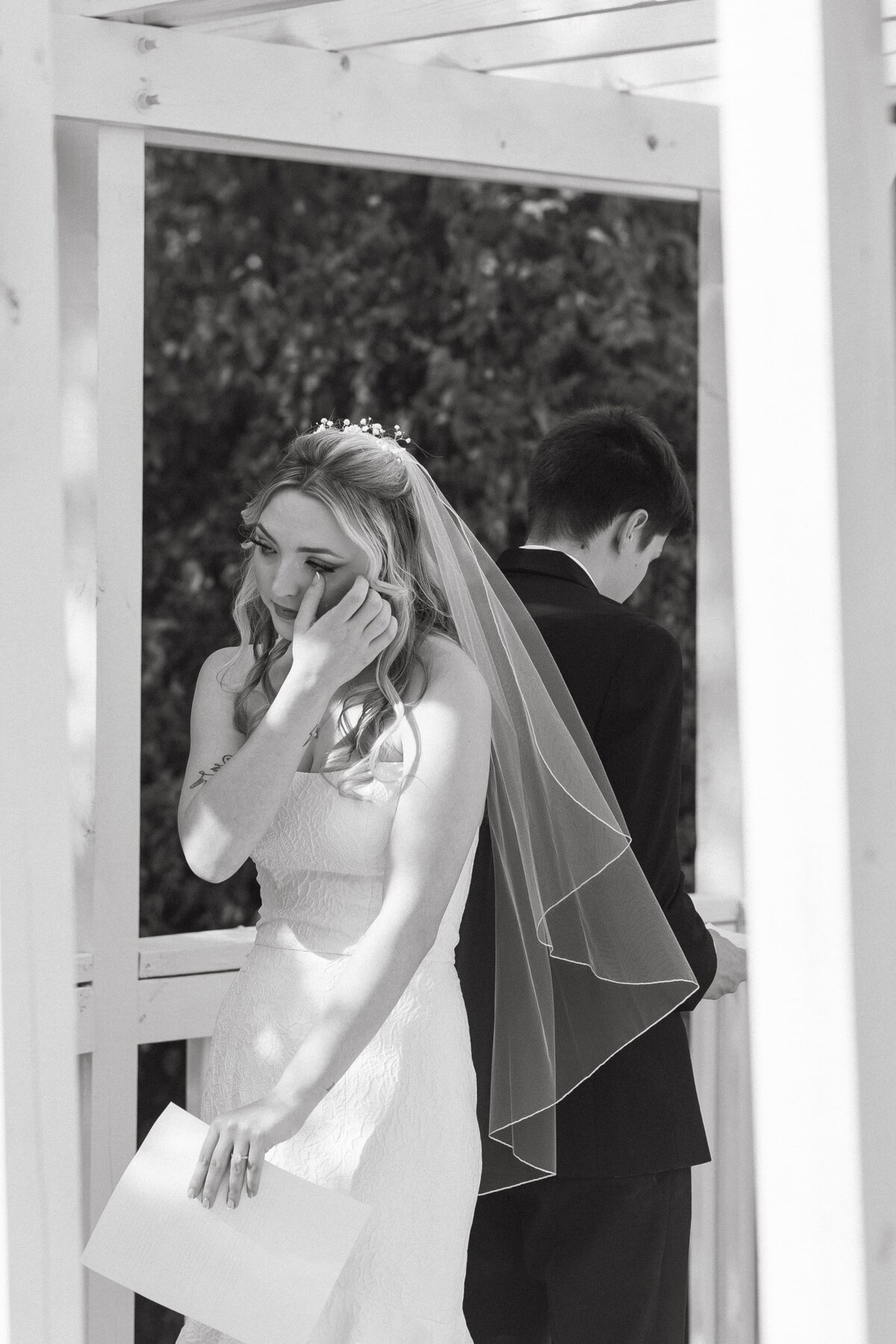 bride wiping tear during vows