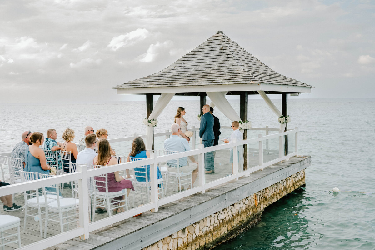a wedding ceremony  by the beach in Jamaica by a destination wedding photographer