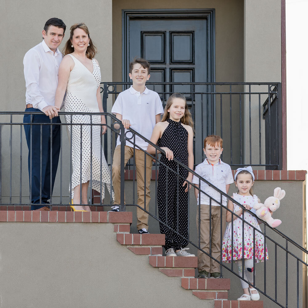 family standing on stair