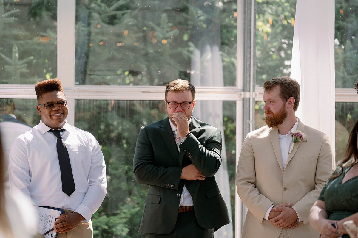 Groom visibly emotional as the bride walks down the aisle at The Ivy House wedding in Saugatuck MI.