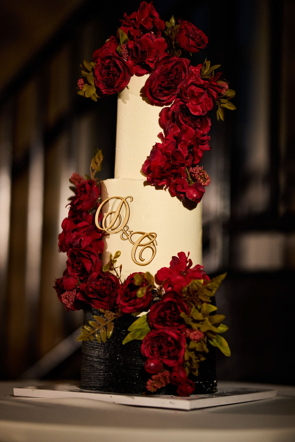 Luxurious wedding cake designed with red flowers