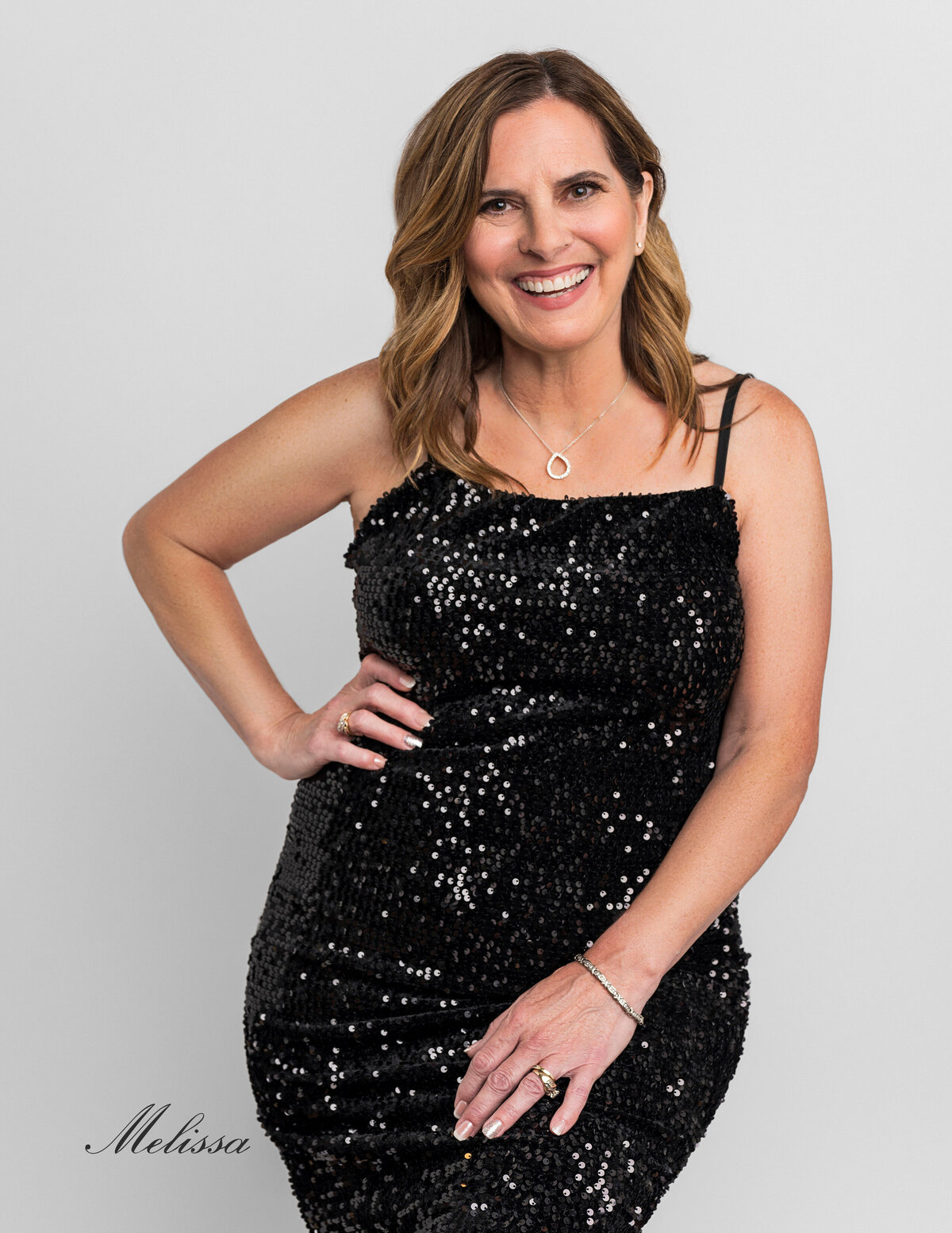 40 Over 40 by Leslie Q  Photography - Sparkling & Confident black dress with elegant smile portrait