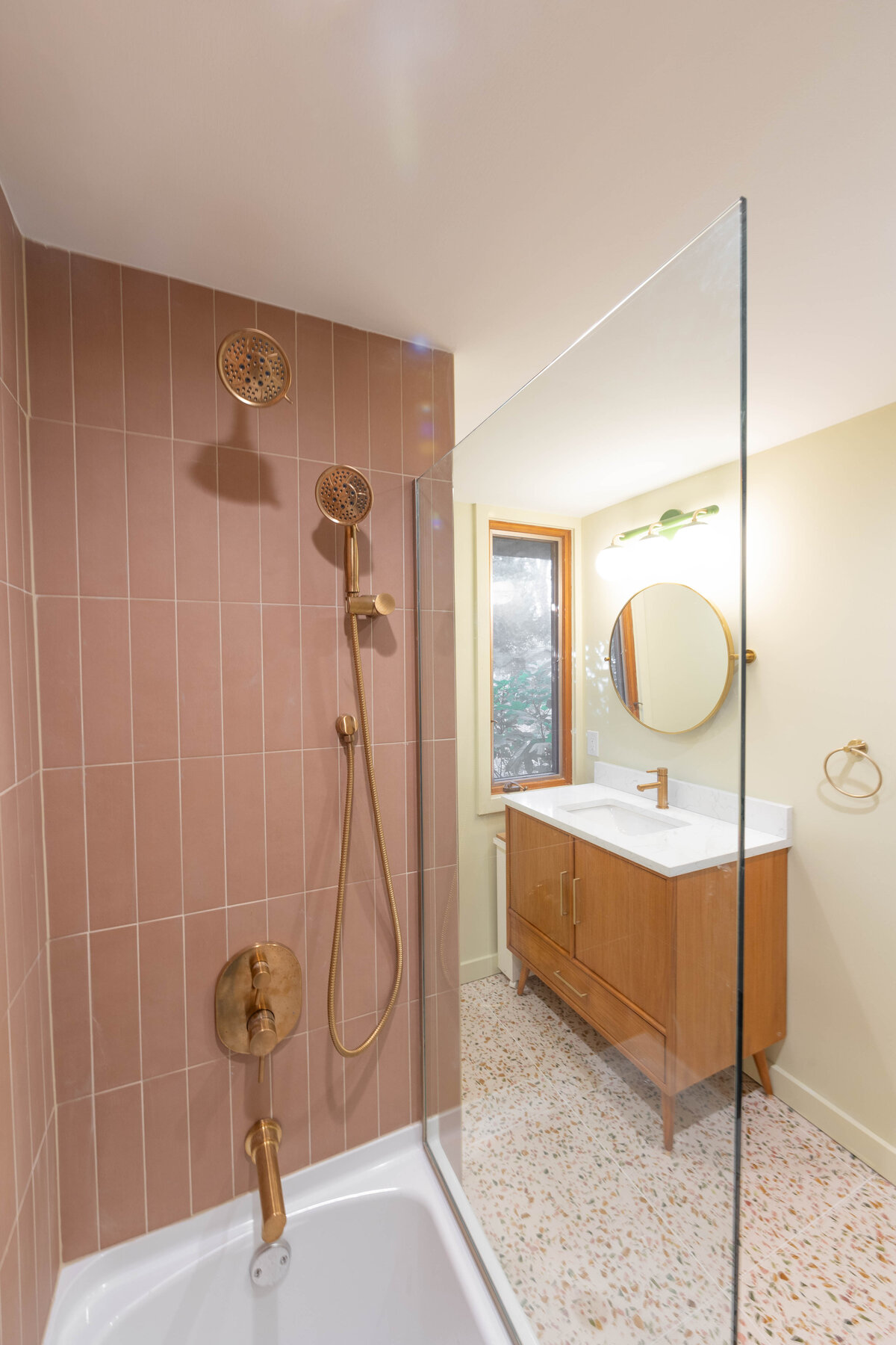 artistic residential bathroom with glass wall and speckled floor