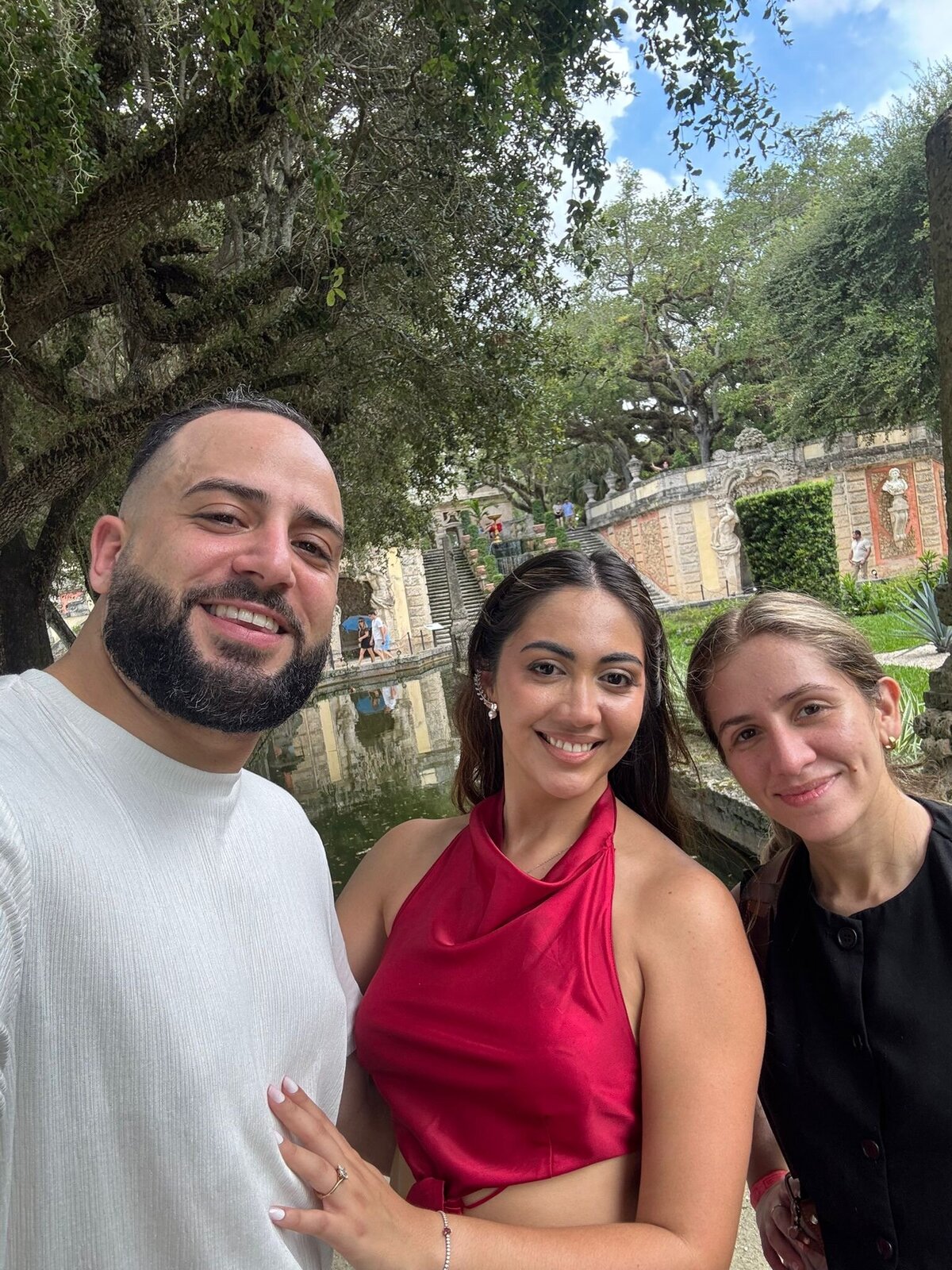 Destination elopement photographer with engaged couple during their Vizcaya Museum engagement session in Miami, surrounded by gardens and stone architecture.