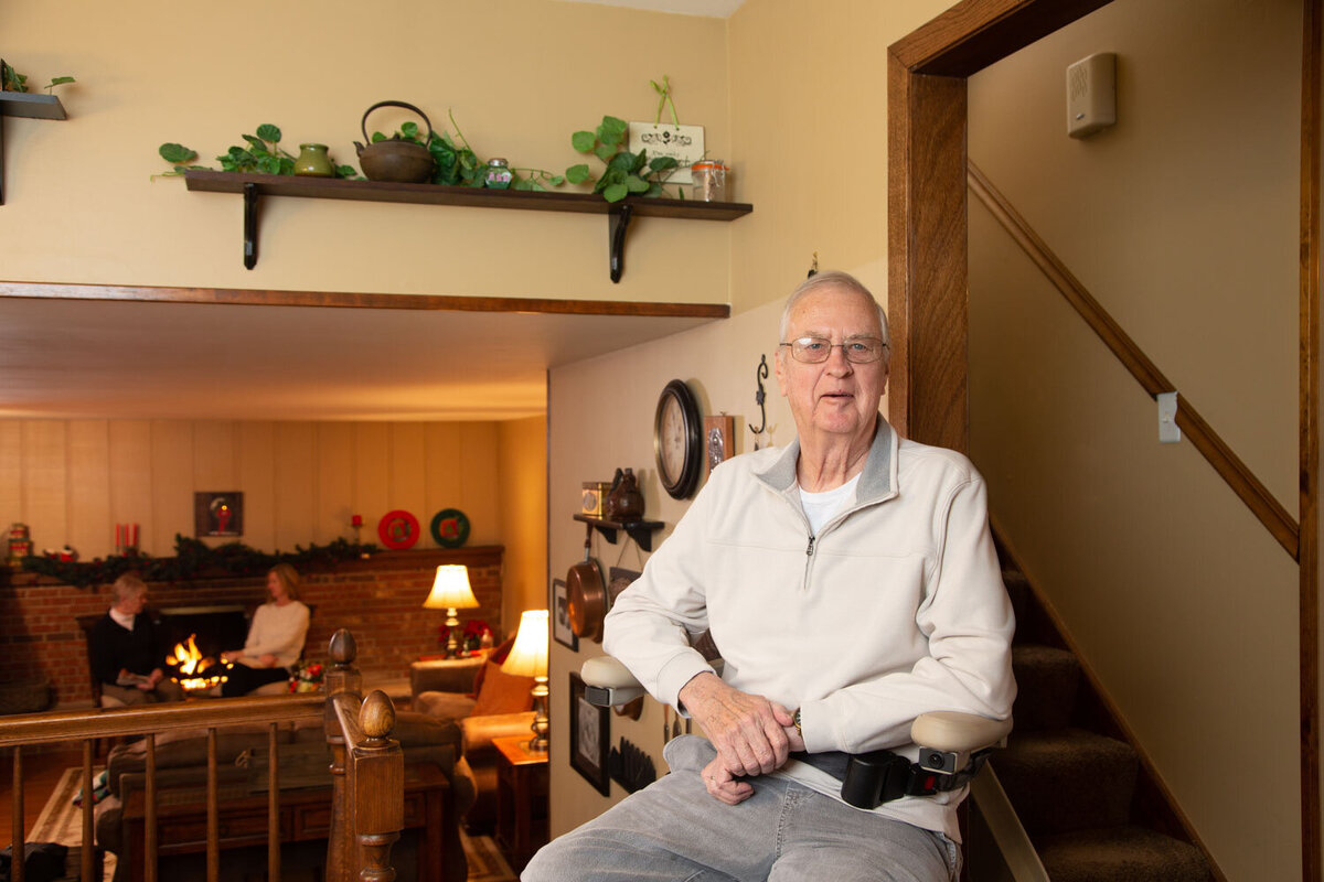 a man in shirt sitting on a mobility chair