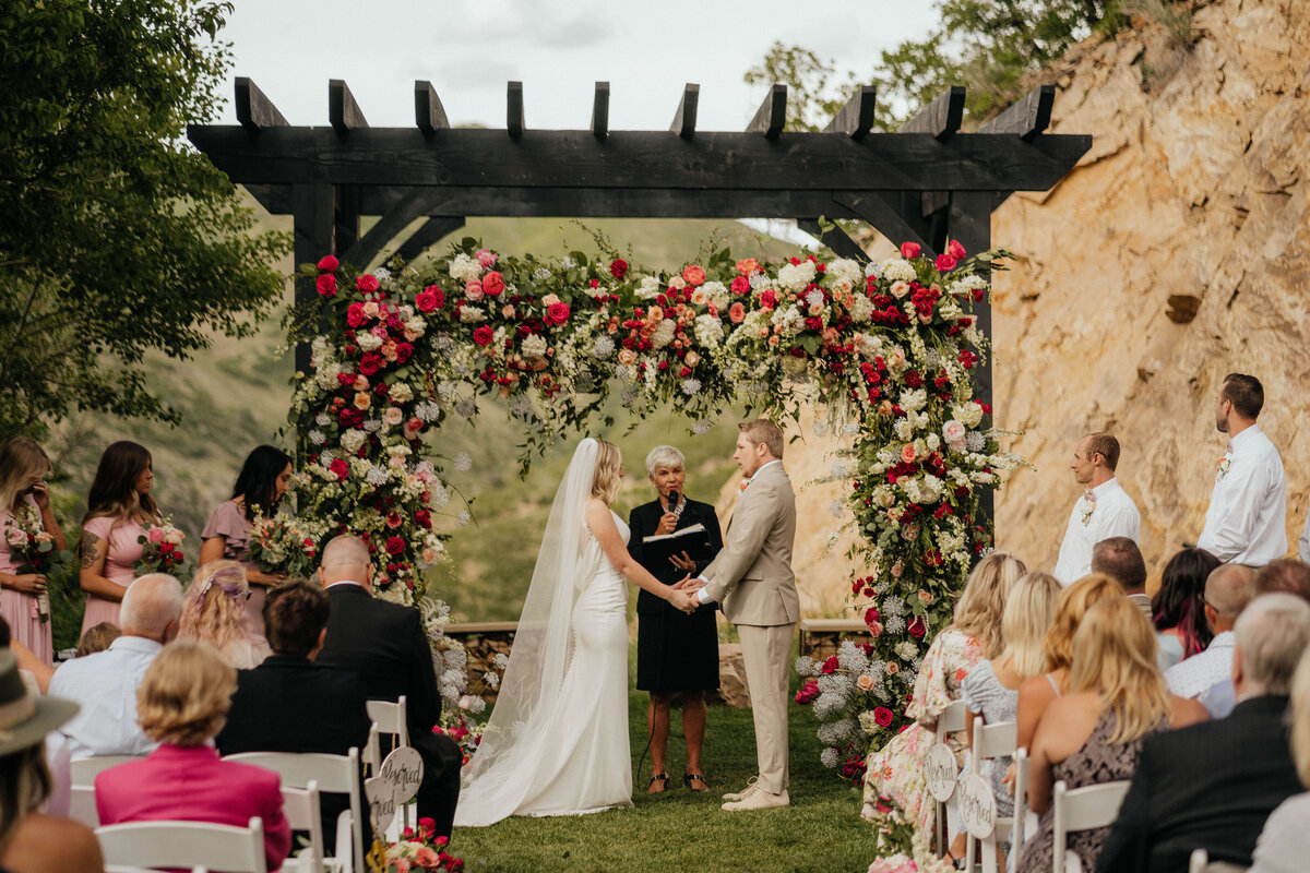 outdoor-summer-mountain-wedding-arch-flowers-utah-jmay-photo