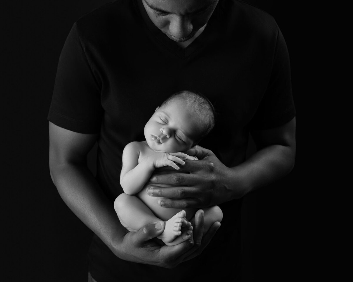 Black white father holding newborn baby Spanish Oaks family photographer