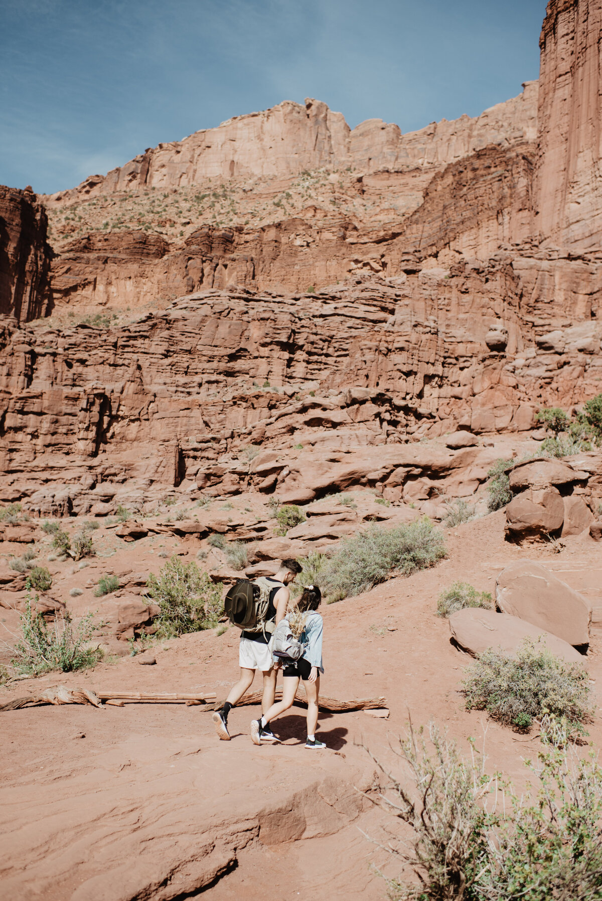 Utah Elopement Photographer captures man and woman walking through Moab