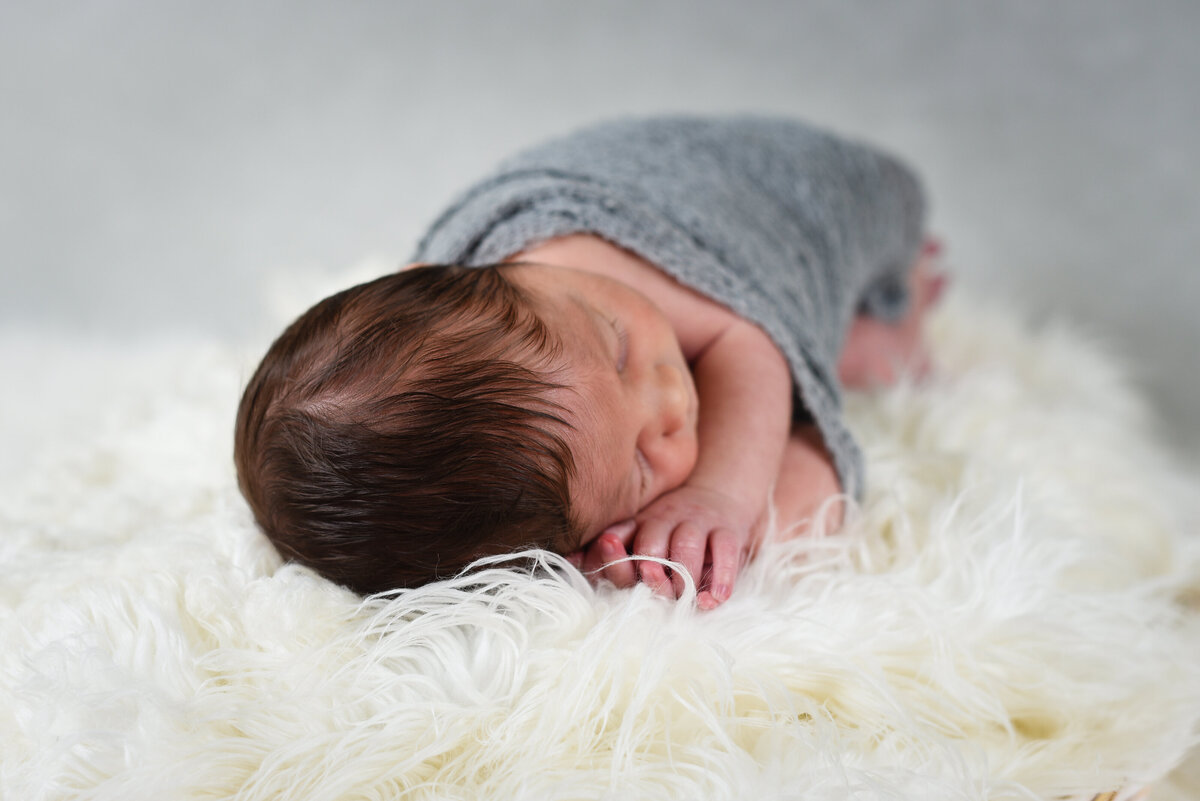 Beautiful Mississippi newborn photography: newborn boy with a head full of dark hair
