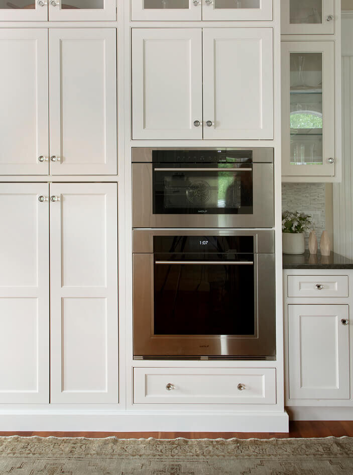 Wolf appliances and white kitchen cabinets by Westwood interior designer, creating a traditional home renovation in Westwood, Massachusetts.