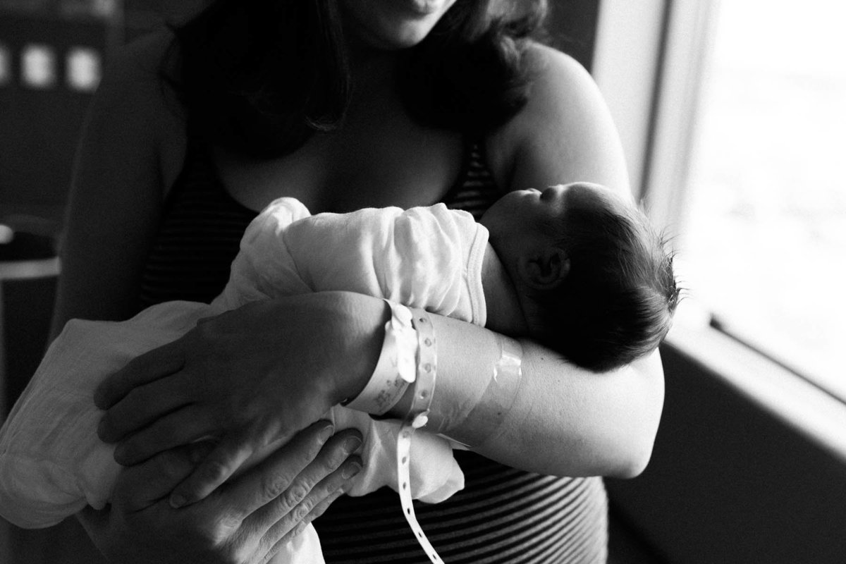 Laurie Baker photographs new mother holding baby boy for the first time