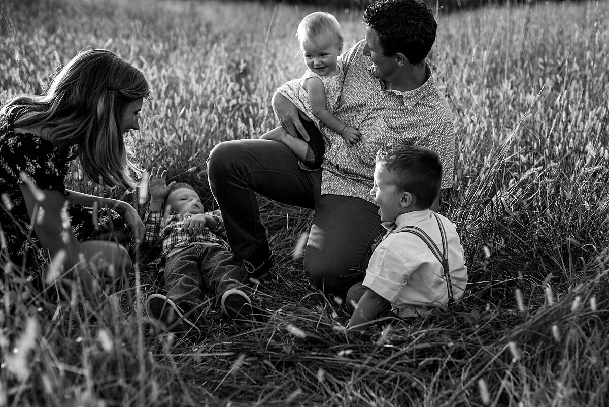 family-laughing and playing-in field