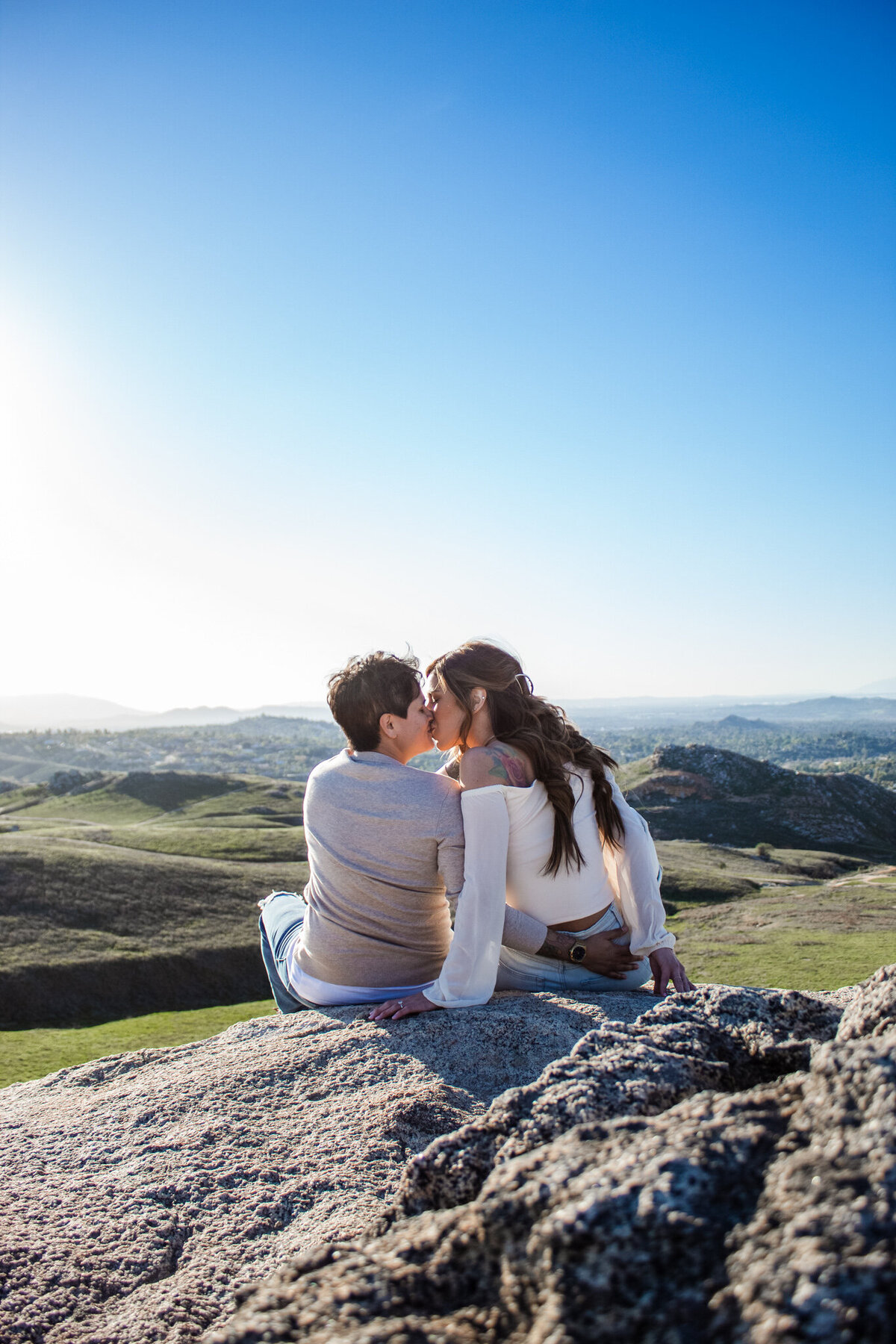 queer couple kisses during engagement session